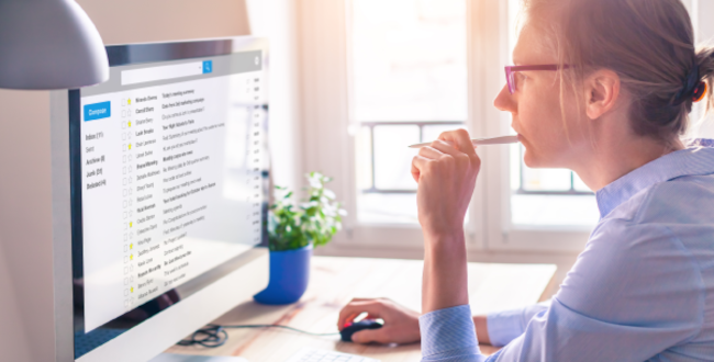 Businesswoman reading email review desktop computer featured img 650x330