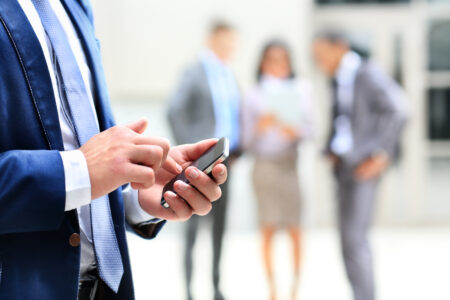 Close up of a man using mobile smart phone