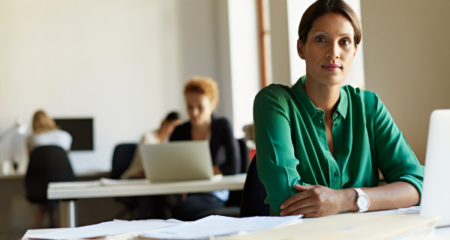 business woman at desk modern office featured img
